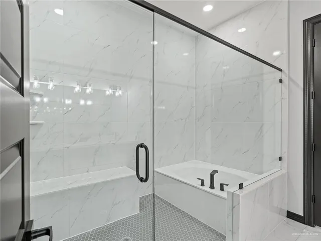 a bathroom with a bathtub and a shower