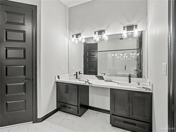 a bathroom with a double vanity sink mirror and