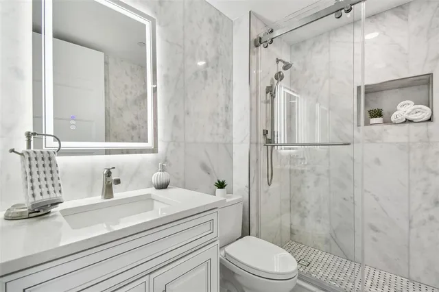 a view of a tennis court with a white building