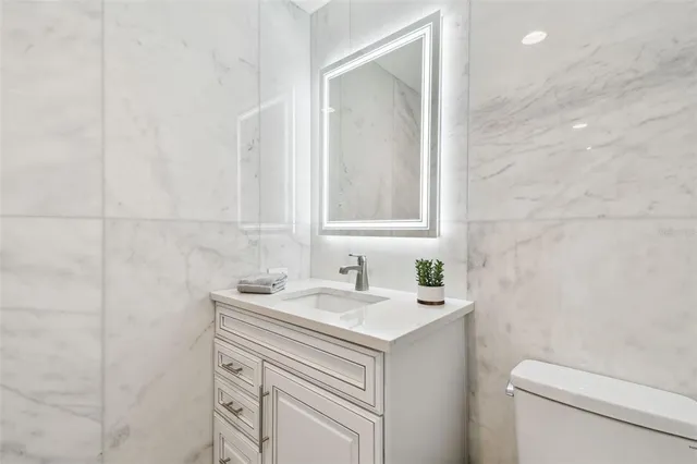 a living room with furniture a flat screen tv and a floor to ceiling window