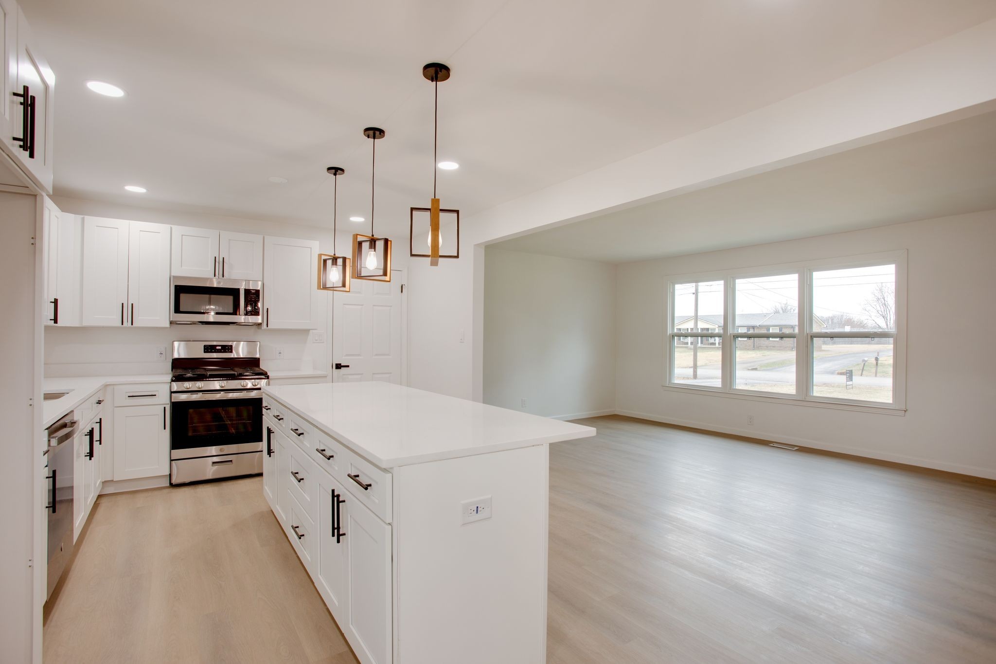 223 Hampton Road Columbia, TN 38401 - Photo 11 of 38 a kitchen with a stove a sink a refrigerator and white cabinets with wooden floor