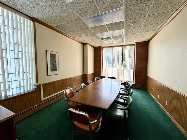 a living room with furniture pool table and large windows
