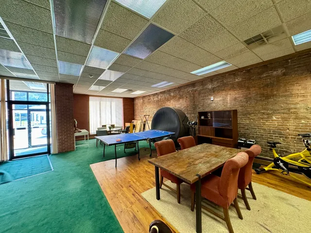 a backyard of a house with table and chairs