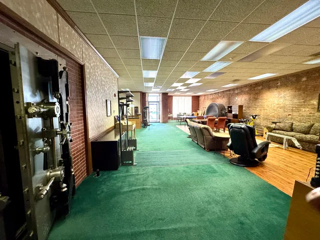 a living room with lots of furniture and a kitchen view