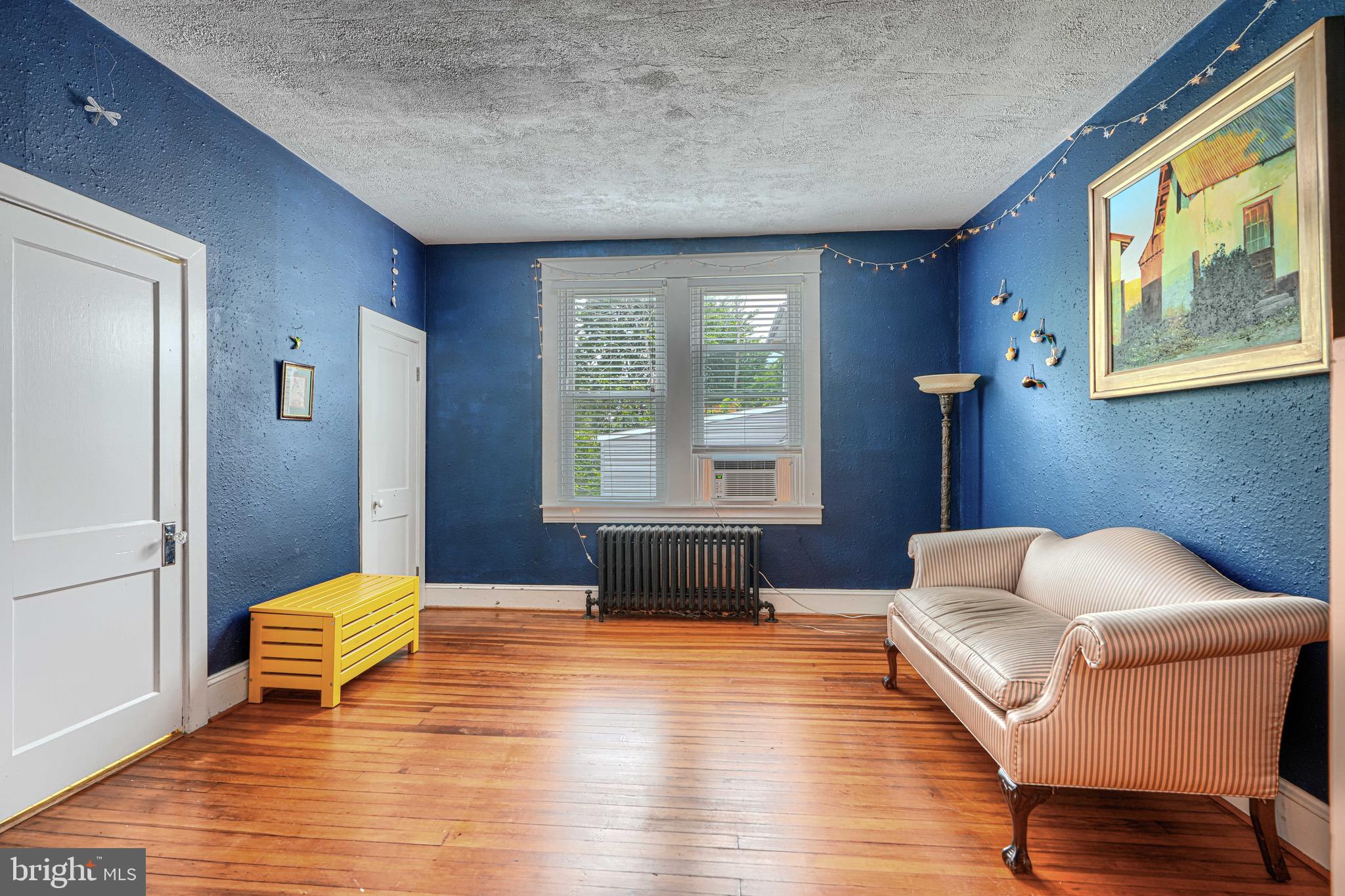 2705 Latona Road Baltimore, MD 21214 - Photo 19 of 53 a bedroom with a bed and wooden floor