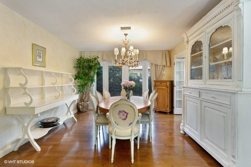 10 Saranac Road Sea Ranch Lakes, FL 33308 - Photo 8 of 26 a view of a dining room with furniture a chandelier and wooden floor