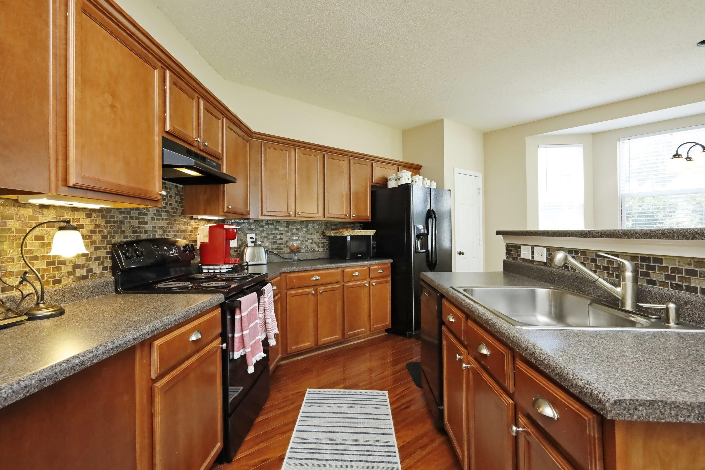 2439 Quarry Ridge Lane Raleigh, NC 27610 - Photo 11 of 41 a kitchen with stainless steel appliances granite countertop a sink stove and refrigerator