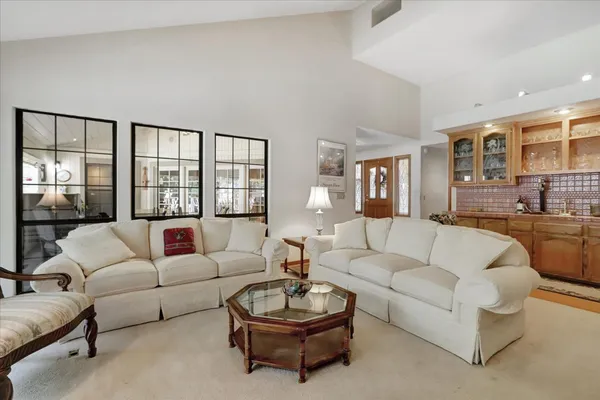 a living room with a bed furniture and a large window