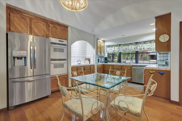 a kitchen with granite countertop a stove sink and cabinets