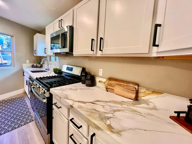 a kitchen with a stove a sink and a refrigerator