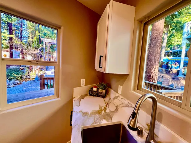 a bathroom with a sink a toilet a mirror and shower