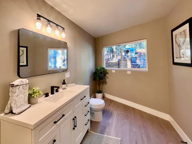 a room with a chandelier and wooden floor