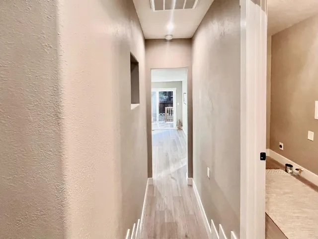 a living room with hard wood floors and a ceiling fan