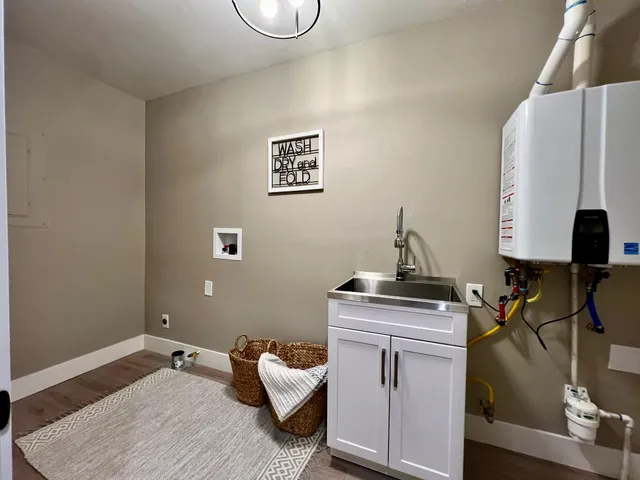 a bathroom with a sink mirror toilet and next to a window