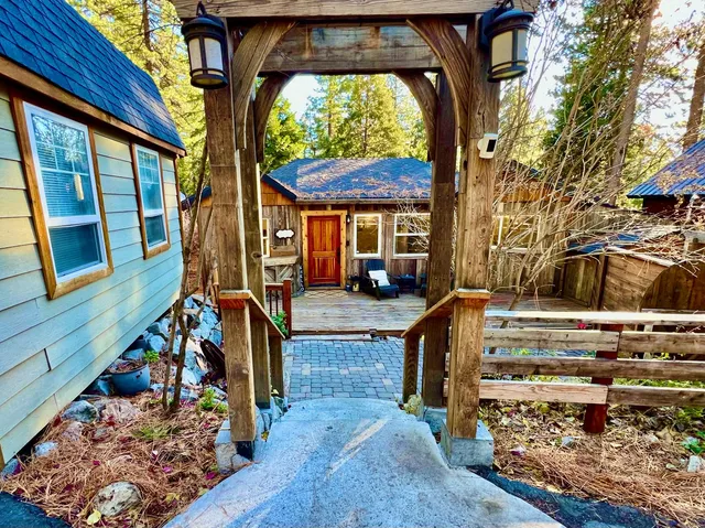 a view of a wooden chairs and a small yard in the patio