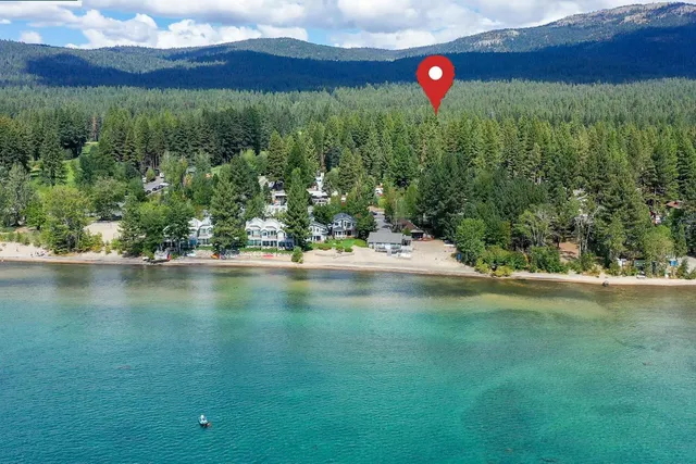 a kitchen with stainless steel appliances a sink dishwasher stove and white cabinets with wooden floor