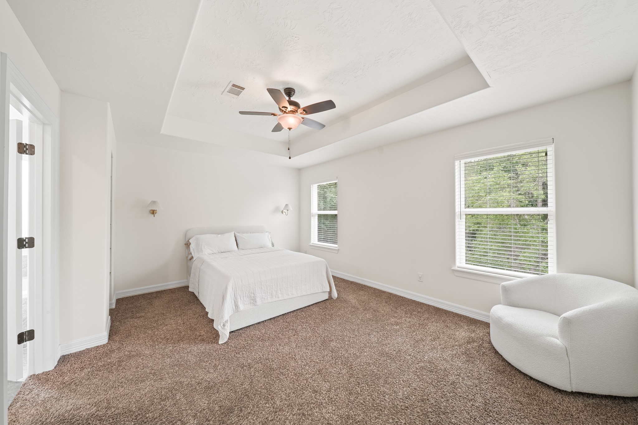 6101 Fox Ridge Drive Angleton, TX 77515 - Photo 17 of 30 a spacious bedroom with a bed a couch and a large window