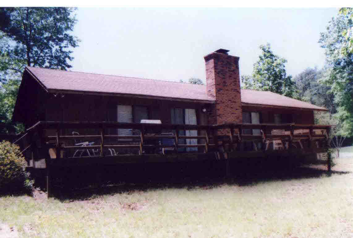 a view of a house with wooden fence