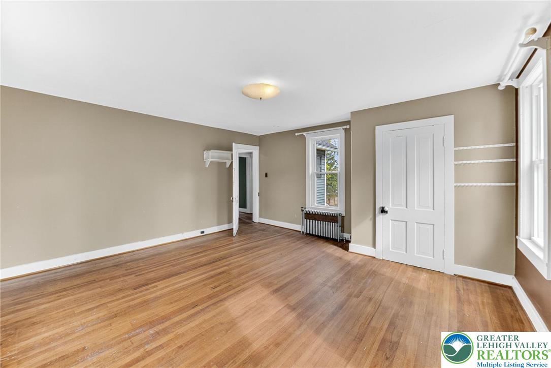 202 Main Street Portland, PA 18343 - Photo 15 of 40 an empty room with wooden floor and windows