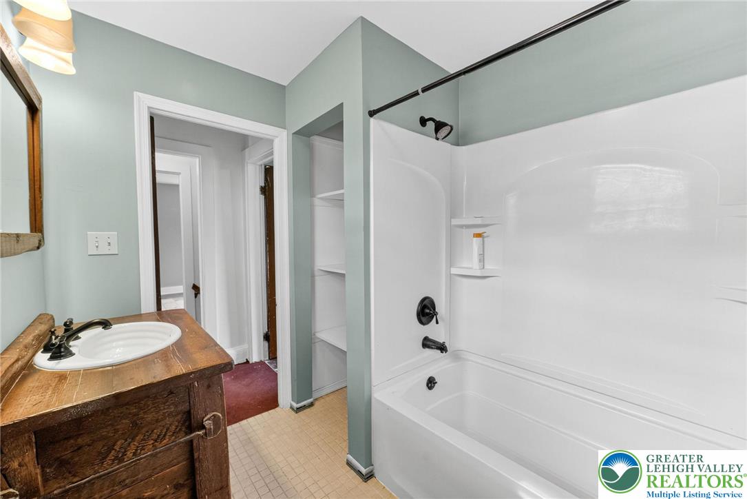 202 Main Street Portland, PA 18343 - Photo 18 of 40 a bathroom with a tub shower sink and vanity