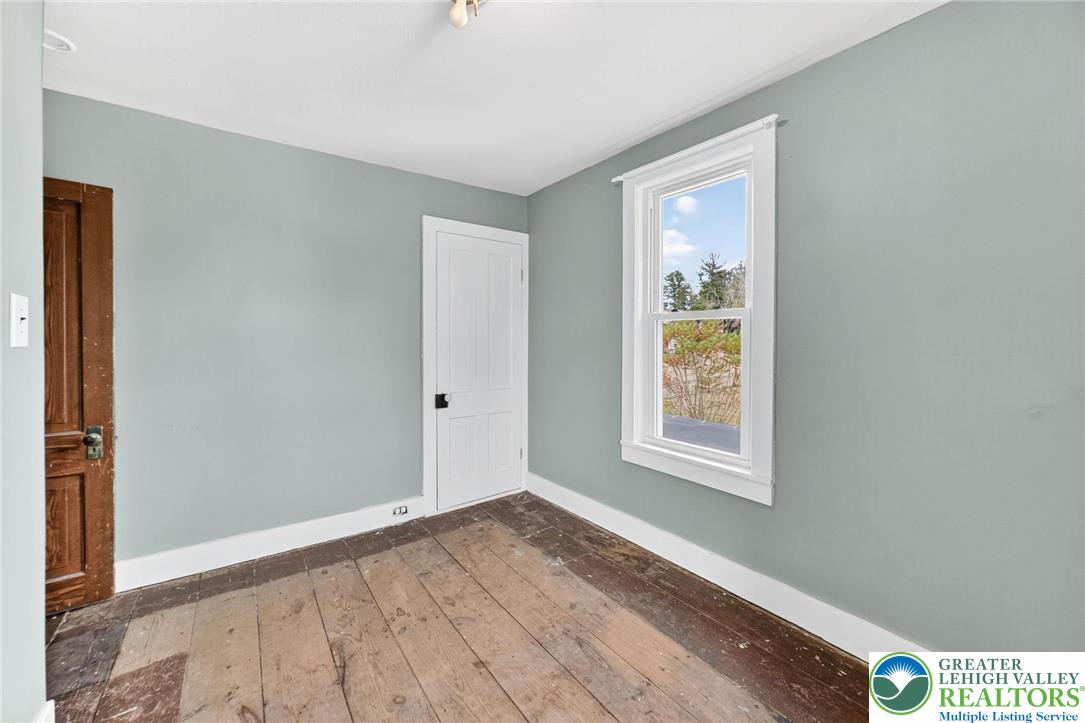 202 Main Street Portland, PA 18343 - Photo 20 of 40 a view of an empty room with wooden floor and a window
