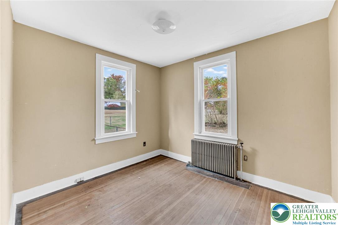 202 Main Street Portland, PA 18343 - Photo 23 of 40 an empty room with wooden floor and windows
