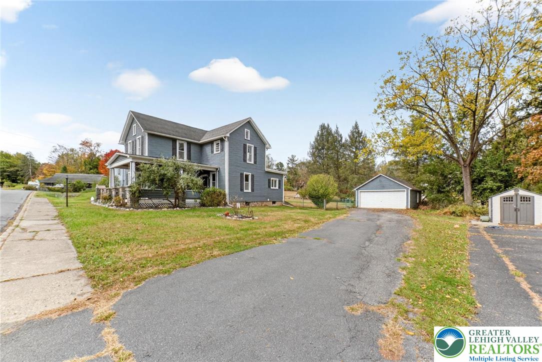 202 Main Street Portland, PA 18343 - Photo 3 of 40 a front view of a house with a yard and garage