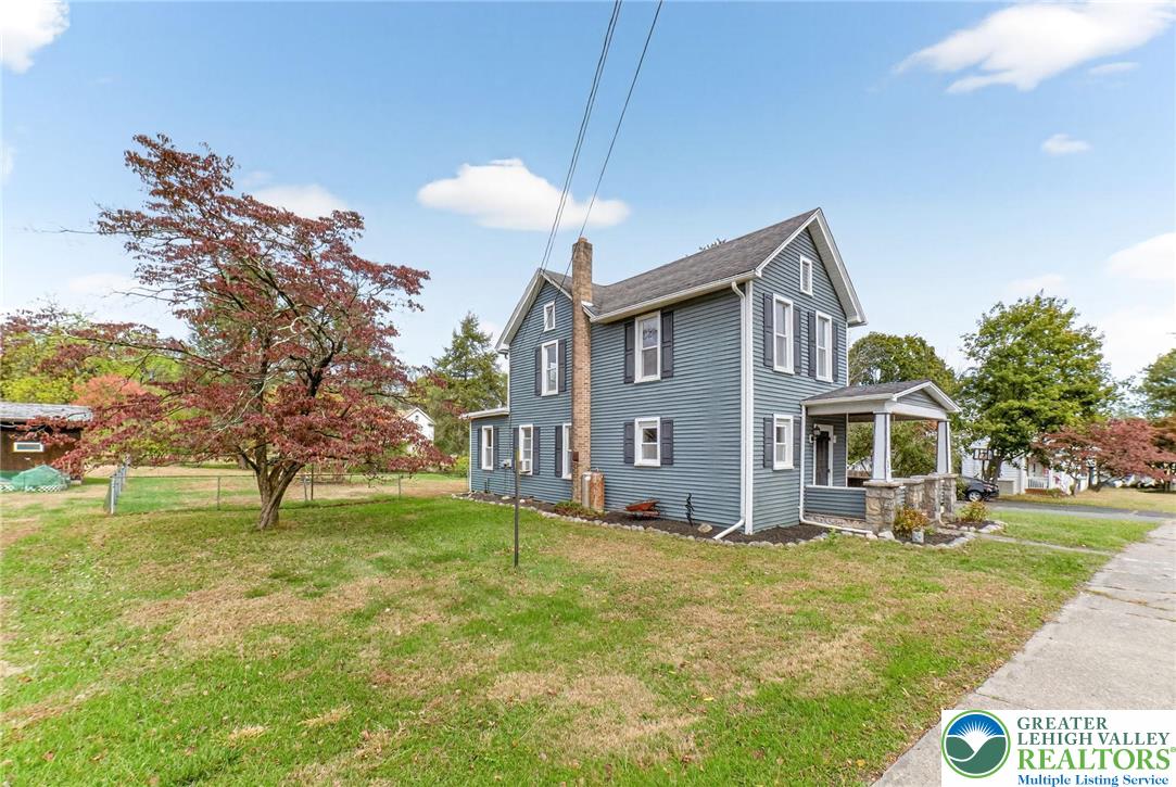 202 Main Street Portland, PA 18343 - Photo 4 of 40 a front view of house with yard and trees in the background