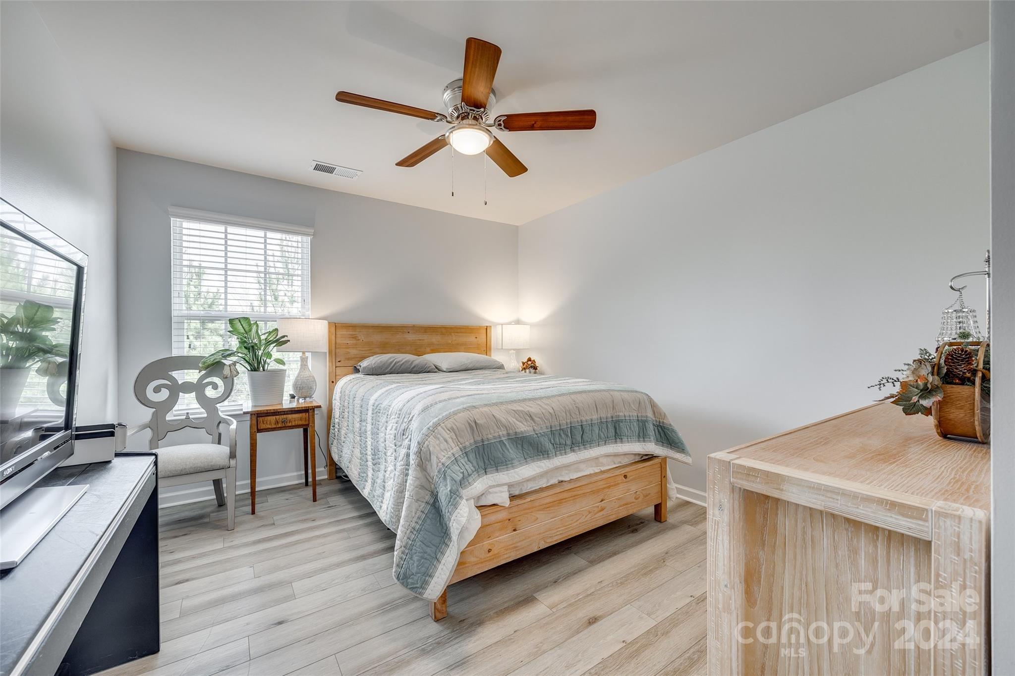 2251 Elmview Lane Fort Mill, SC 29715 - Photo 19 of 46 a bedroom with a bed and wooden floor