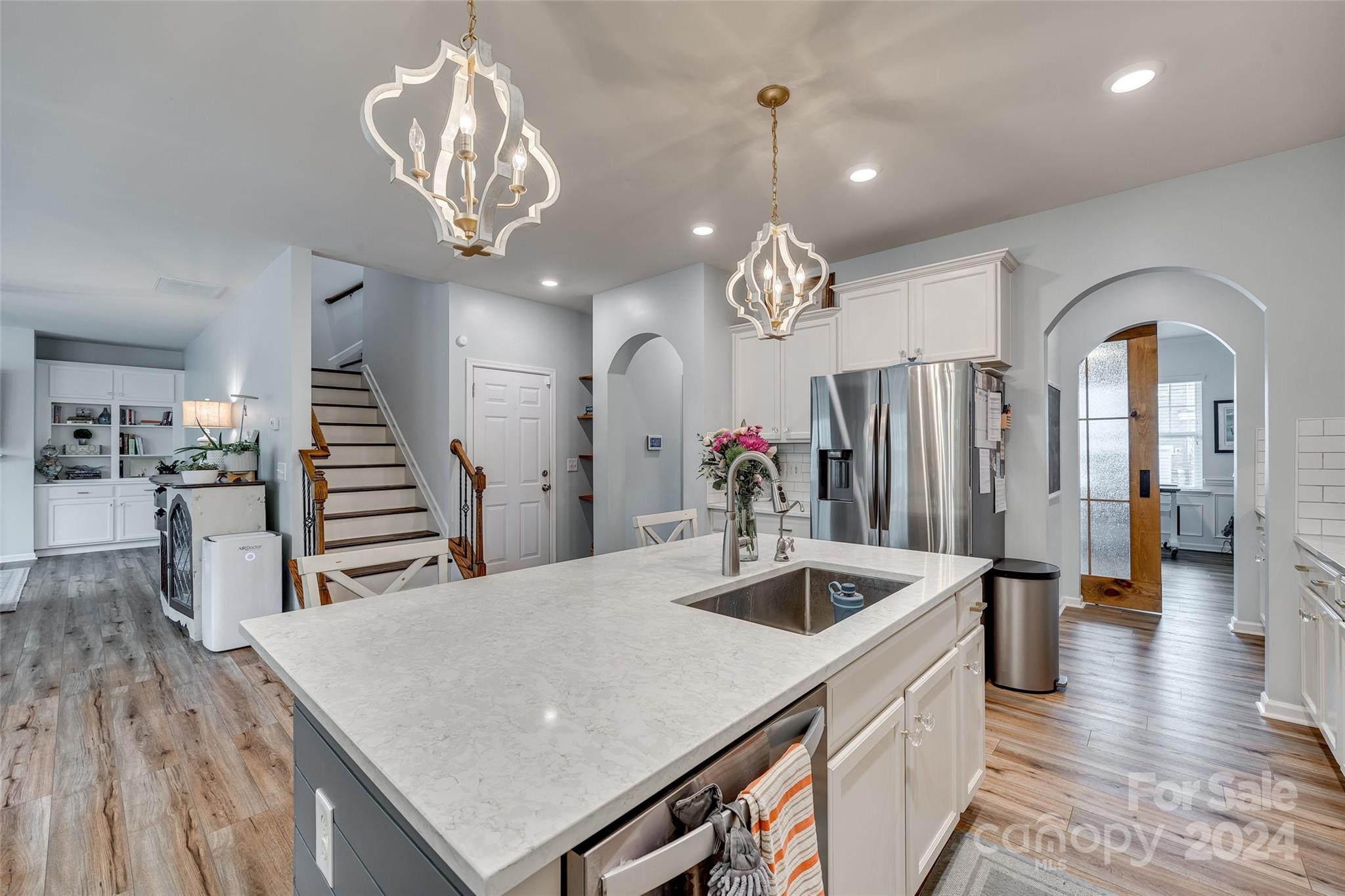 2251 Elmview Lane Fort Mill, SC 29715 - Photo 8 of 46 a kitchen with stainless steel appliances kitchen island granite countertop a table chairs and a refrigerator