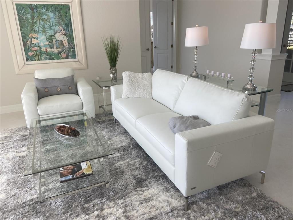 3840 Rudder Way New Port Richey, FL 34652 - Photo 3 of 18 a living room with a couch and a table