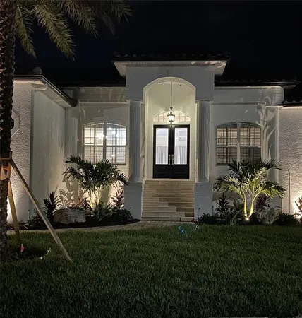 a front view of a house with a garden