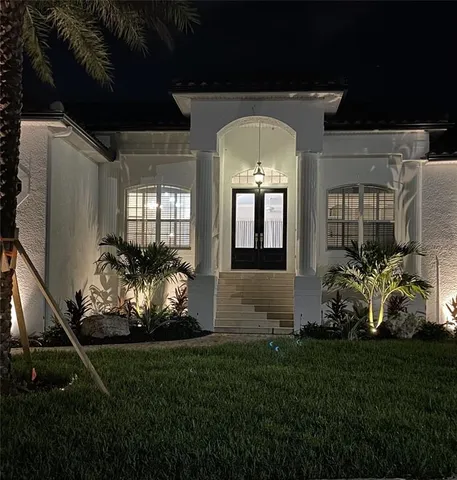 a front view of a house with a garden