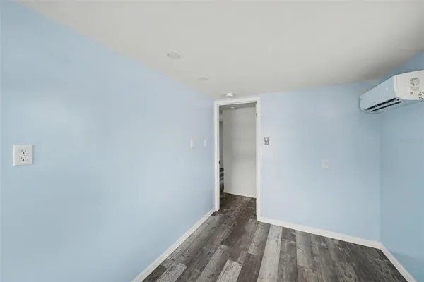 a view of a room with wooden floor