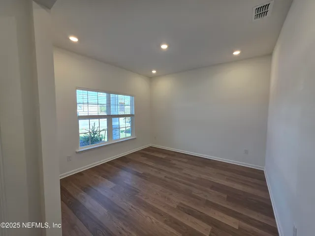 a spacious bathroom with a double vanity sink a mirror and a shower