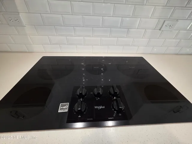 an empty room with a piano and windows