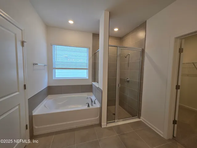a large kitchen with stainless steel appliances refrigerator sink and cabinets