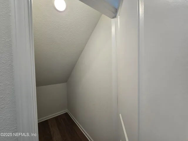 a view of an empty room and a window