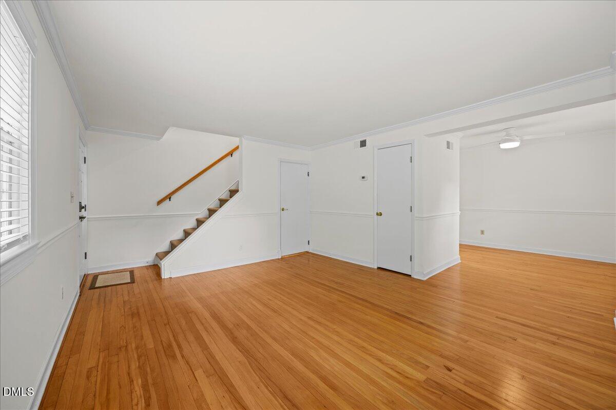 1627 Sutton Drive Raleigh, NC 27605 - Photo 7 of 33 a view of an empty room with wooden floor