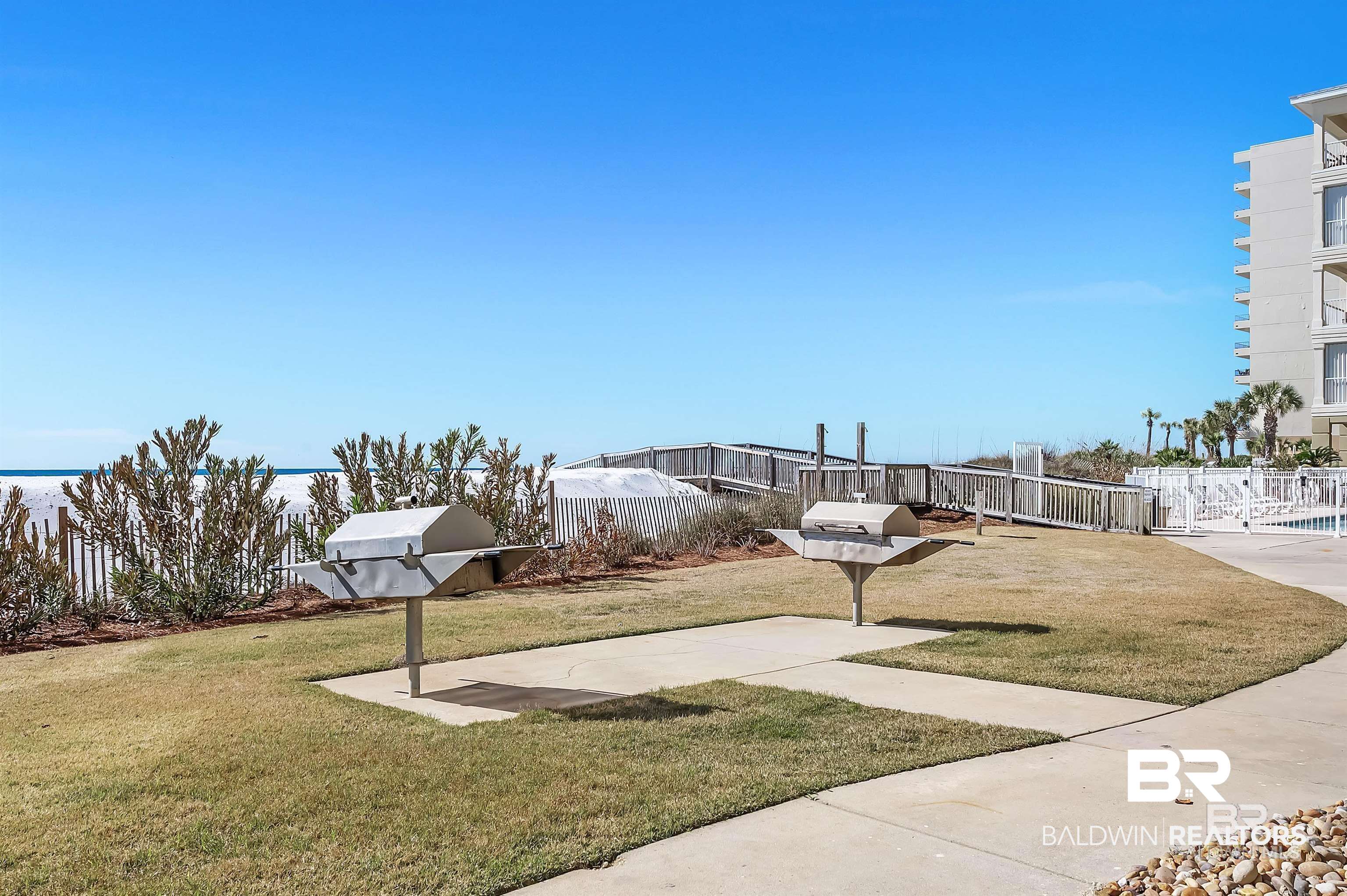 28910 Perdido Beach Boulevard, Unit 4B Orange Beach, AL 36561 - Photo 42 of 48 View of home's community featuring fence and a lawn