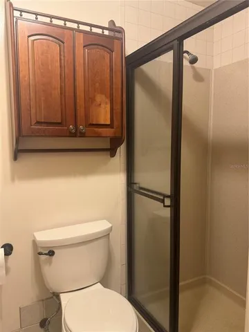 a bathroom with a shower and a toilet