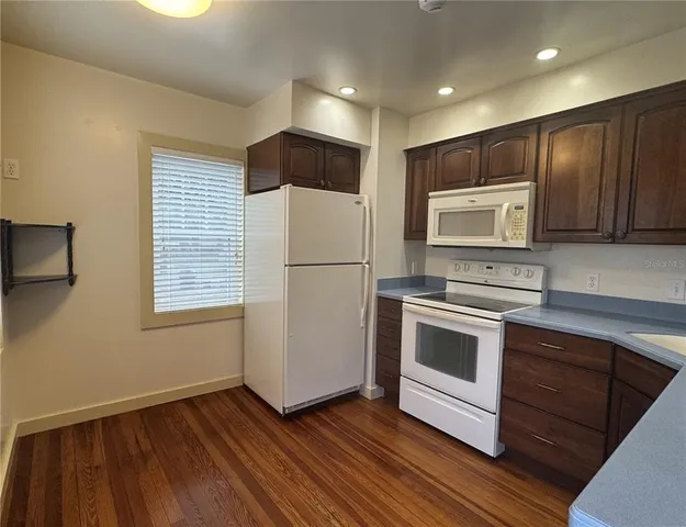 a kitchen with stainless steel appliances a stove a sink and a microwave