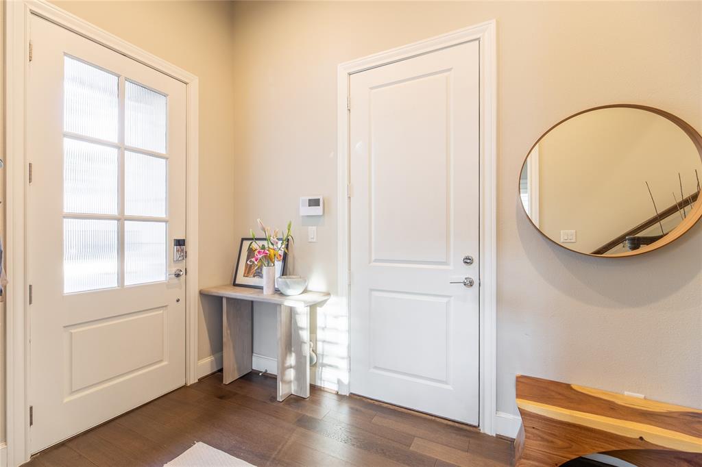 4116 Runyon Road Addison, TX 75001 - Photo 5 of 31 an entryway with wooden floor and a cabinet