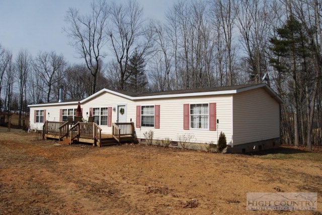709 Lazy Branch Road Ennice, NC 28623 - Photo 1 of 7 a front view of a house with a yard