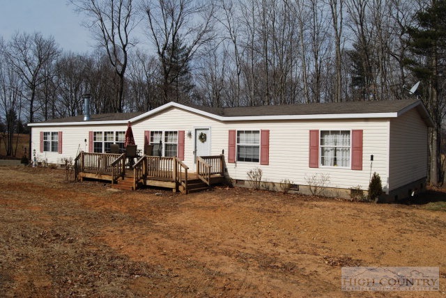 709 Lazy Branch Road Ennice, NC 28623 - Photo 2 of 7 a front view of a house with yard