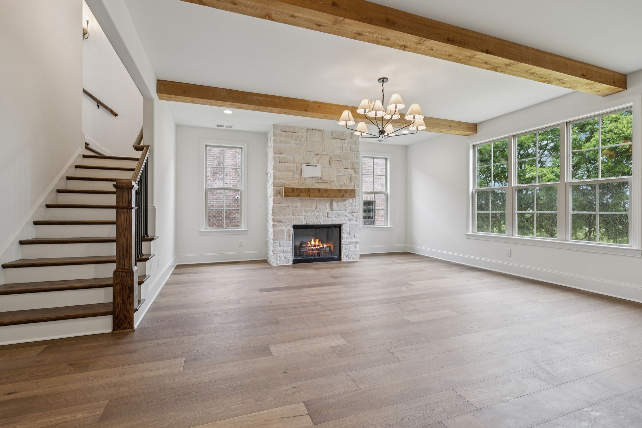 217 Bellsford Road Gallatin, TN 37066 - Photo 14 of 73 a view of an empty room with wooden floor fireplace and chandelier