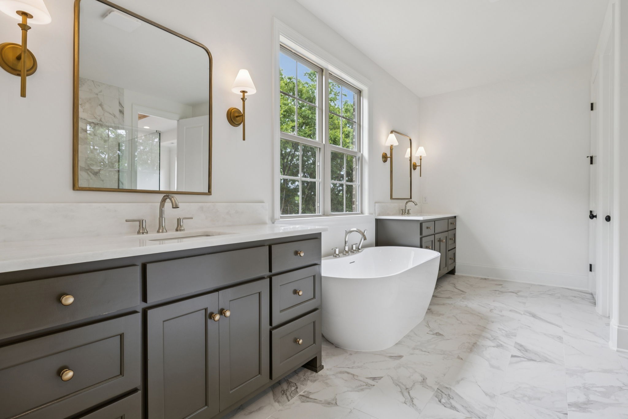 217 Bellsford Road Gallatin, TN 37066 - Photo 33 of 73 a spacious bathroom with a double vanity sink a mirror and a bathtub