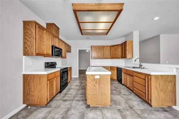 a kitchen with stainless steel appliances a stove a sink a microwave and cabinets