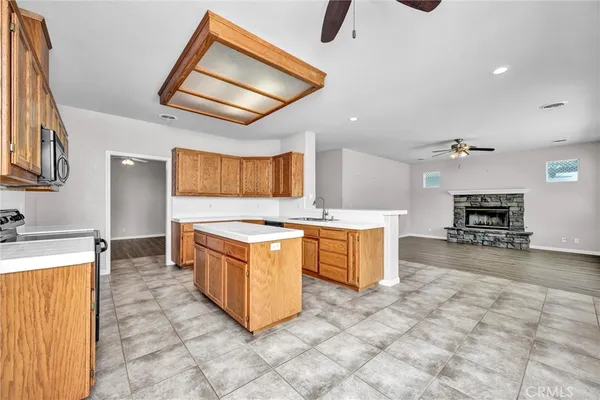 a large kitchen with stainless steel appliances granite countertop a stove and a sink