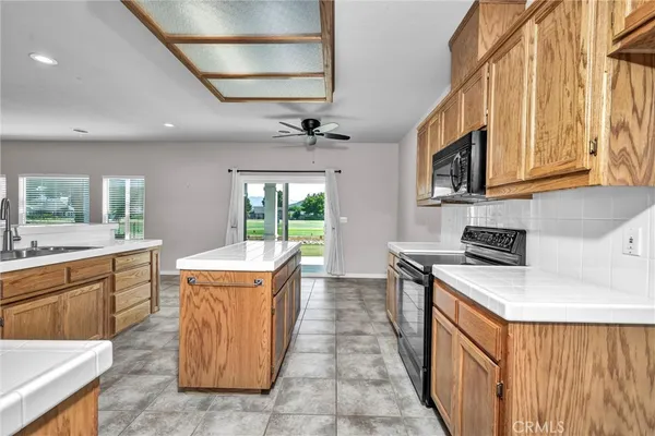 a kitchen with a stove top oven sink and a refrigerator